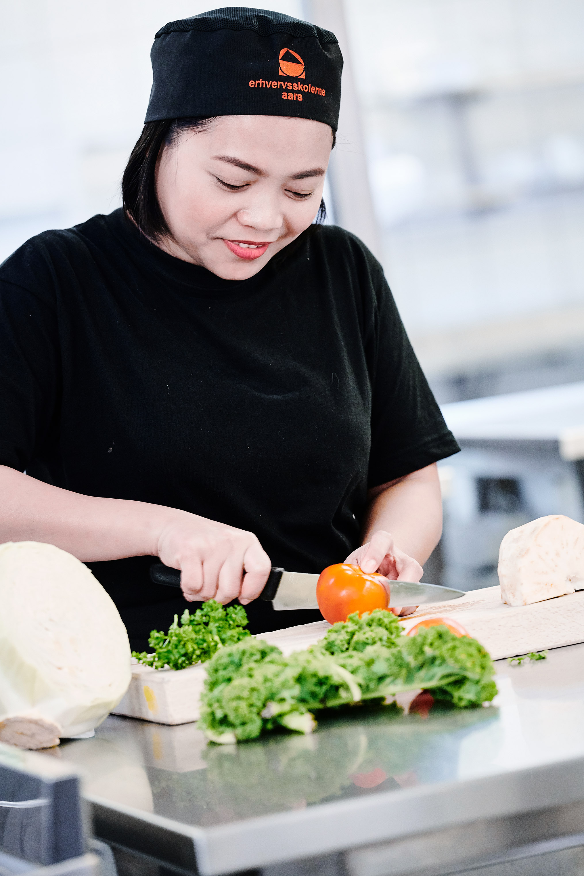 Elev fra uddannelsen fødevarer, jordbrug og oplevelser i gang med at skære grøntsager